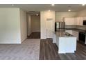 Open-concept kitchen features stainless steel appliances, granite counters and a center island at 605 Muster Field Ct., Conway, SC 29526