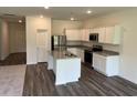 Modern kitchen boasts stainless steel appliances, granite countertops, and a functional center island at 605 Muster Field Ct., Conway, SC 29526