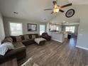 View of the modern living room flowing into a kitchen with stainless steel appliances and granite countertops at 7370 Johnson Shortcut Rd., Conway, SC 29527