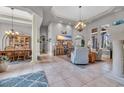 Open concept living space featuring high ceilings, tile floors, and elegant chandelier at 7470 Seville Dr., Myrtle Beach, SC 29572