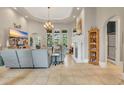 Expansive living room with high ceilings, tile floors, fireplace, and natural light at 7470 Seville Dr., Myrtle Beach, SC 29572