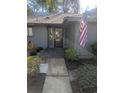 Home's entryway with glass door and the American flag, showcasing a neat garden at 880 Briarwood Dr., Myrtle Beach, SC 29572
