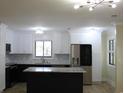 Bright kitchen with stainless steel appliances, island, and stylish marble backsplash at 880 Briarwood Dr., Myrtle Beach, SC 29572