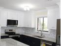 Modern kitchen features white cabinets, stainless steel appliances, and marble countertops at 880 Briarwood Dr., Myrtle Beach, SC 29572