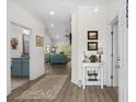 Inviting foyer featuring hardwood floors, neutral paint, and views of living area and bath at 948 Jackline Place # 201, Murrells Inlet, SC 29576