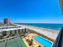 Aerial view of beachside condominiums featuring a tennis court and pool with ocean views at 9650 Shore Dr. # 810, Myrtle Beach, SC 29572