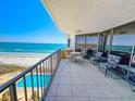 Spacious balcony with chairs and ocean views overlooking the pool and beach at 9650 Shore Dr. # 810, Myrtle Beach, SC 29572