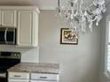 This kitchen shows granite countertops, stainless steel appliances, and decorative lighting at 1516 Saint George Ln., Myrtle Beach, SC 29588