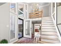 Bright foyer with staircase, modern chandelier, and hardwood flooring at 1646 Bay Tree Ln., Surfside Beach, SC 29575