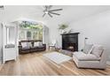 Cozy living room featuring a ceiling fan, fireplace, and hardwood flooring at 1646 Bay Tree Ln., Surfside Beach, SC 29575