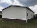 Back of home with vinyl siding and brick base with grass yard at 212 Weyburn St., Myrtle Beach, SC 29579