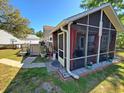 Inviting screened porch with patio and potted plants for outdoor relaxation at 2488 Oriole Dr., Murrells Inlet, SC 29576