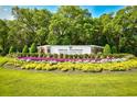 Pawleys Plantation Golf and Country Club entrance with beautiful flower beds and lush greenery at 273 Golden Bear Dr. # F3, Pawleys Island, SC 29585