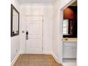 Clean and bright entryway with white walls, light wood floors, and access to a half bath at 273 Golden Bear Dr. # F3, Pawleys Island, SC 29585