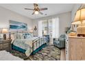 Cozy bedroom featuring a comfortable bed, stylish decor, and ample natural light from the window at 296 Switchgrass Loop, Little River, SC 29566
