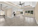 Open concept living space with tile flooring, tray ceiling, and views of the kitchen and backyard at 331 Las Olas Dr., Myrtle Beach, SC 29577