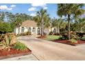 Lovely one-story home showcasing a spacious driveway and beautifully landscaped front yard at 4016 Atalaya Pl., Myrtle Beach, SC 29579