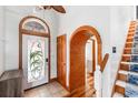 Inviting foyer with tile floors, arched doorways, and a unique stained-glass front door with a tropical design at 4240 Highway 17 Business, Murrells Inlet, SC 29576