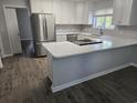 Modern kitchen featuring stainless steel appliances, white cabinets, and quartz countertops at 501 Hillside Dr. N, North Myrtle Beach, SC 29582