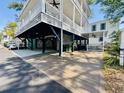 Spacious outdoor entertaining area under elevated beach home with wood flooring at 6001 - 1322 S Kings Hwy., Myrtle Beach, SC 29575