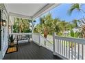Covered porch features a bench, outdoor lighting, painted wood floor, and a decorative welcome mat at 811 10Th Ave. S, Surfside Beach, SC 29575