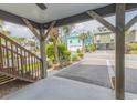 View of street from covered outdoor space featuring wooden support beams at 93 Weatherboard Ct., Pawleys Island, SC 29585