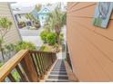 View from top of wooden staircase showing neighboring raised beach homes at 93 Weatherboard Ct., Pawleys Island, SC 29585