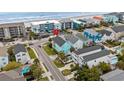 An aerial shot showcases the home's proximity to the beach, highlighting nearby amenities and neighborhood at 1010B S Ocean Blvd., Surfside Beach, SC 29575