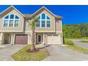 Inviting townhome boasts an attached garage and a beautifully landscaped front yard at 105 Villa Mar Dr. # C-1, Myrtle Beach, SC 29579