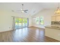 Bright living room features vaulted ceilings, wood floors, and sliding doors to the deck at 105 Villa Mar Dr. # C-1, Myrtle Beach, SC 29579