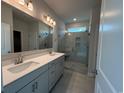 Modern bathroom featuring double sinks, a glass-enclosed shower, and contemporary fixtures at 1051 Laconic Dr., Myrtle Beach, SC 29588