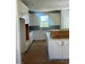 Bright kitchen featuring white cabinets, tiled backsplash, and lots of counter space at 1237 Lady Bird Way, North Myrtle Beach, SC 29582