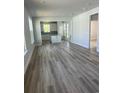 Bright, open-concept living area featuring hardwood floors and natural light at 1237 Lady Bird Way, North Myrtle Beach, SC 29582