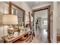Hallway with a decorative table and mirror featuring a view into the connected living spaces at 233 Astoria Park Loop, Conway, SC 29526