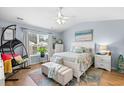 Inviting bedroom with a ceiling fan, plenty of natural light, and coastal decor at 328 Logan St., Little River, SC 29566