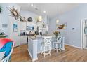 Bright kitchen featuring a granite breakfast island, white cabinets, and pendant lighting at 328 Logan St., Little River, SC 29566