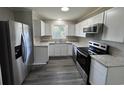 An updated kitchen featuring stainless steel appliances, white cabinets, and granite countertops at 333 Whites Creek Rd., Georgetown, SC 29440