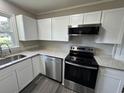 Updated kitchen with stainless steel appliances, modern white cabinets, and granite countertops at 333 Whites Creek Rd., Georgetown, SC 29440