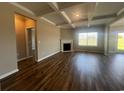 Open living room featuring hardwood floors, a fireplace, coffered ceilings, and an abundance of natural light at 4027 Bucolic Loop, Myrtle Beach, SC 29588