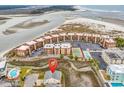 Stunning aerial view of a beautiful home near the beach and ocean, with nearby condos and a tennis court at 6302 Nixon St., North Myrtle Beach, SC 29582