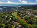 Stunning aerial view of a home on a golf course, with water and other homes visible at 710 Masters Dr., Pawleys Island, SC 29585