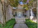 Inviting front porch with brick steps, pillars, and mature trees and landscaping at 710 Masters Dr., Pawleys Island, SC 29585