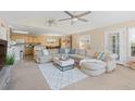 Inviting living area with a large sectional sofa, ceiling fan, and open layout to the kitchen at 10 Logan Berry Ct. # H, Murrells Inlet, SC 29576