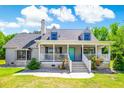 Inviting exterior view of home featuring a welcoming front porch and blue door at 2400 Bay View Dr., Green Sea, SC 29545