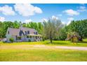 Exterior of charming home with inviting front porch and lush green lawn at 2400 Bay View Dr., Green Sea, SC 29545