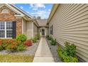 Inviting front entrance with a walkway, lovely landscaping, and a charming front door at 293 Hillsborough Dr., Conway, SC 29526