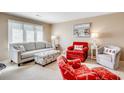 Cozy living room with nautical decor, a gray sofa and a bright red armchair at 4504 S Ocean Blvd. # A, North Myrtle Beach, SC 29582