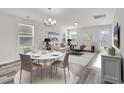 Bright open floor plan features a dining area and living space with sleek floors and lots of natural light at 500 Dundalk Dr., Conway, SC 29526