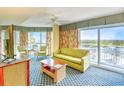 Living room with comfortable seating, beautiful floral curtains, and great views at 5300 N Ocean Blvd. # 923, Myrtle Beach, SC 29577
