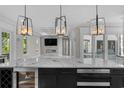 Modern kitchen featuring marble countertop island, pendant lights, stainless steel appliances, and open access to the living room at 100 Serenity Point Dr., Little River, SC 29566